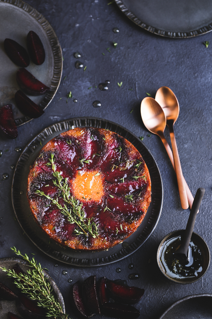 This tiny gluten free plum cake is laced with tangy lemon thyme syrup, and showcases jewelled plum tones in a delightful small batch autumn treat.
