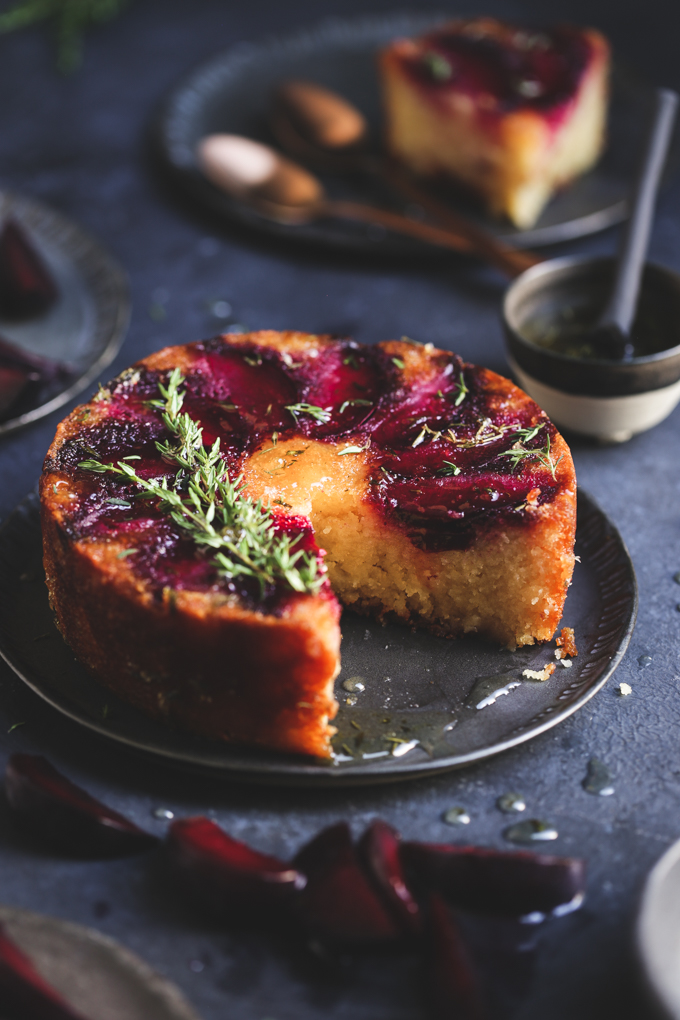 This tiny gluten free plum cake is laced with tangy lemon thyme syrup, and showcases jewelled plum tones in a delightful small batch autumn treat.