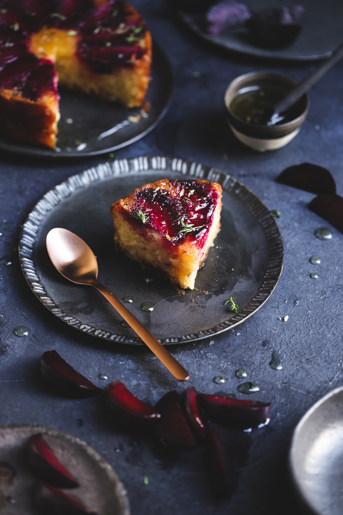 This tiny gluten free plum cake is laced with tangy lemon thyme syrup, and showcases jewelled plum tones in a delightful small batch autumn treat.